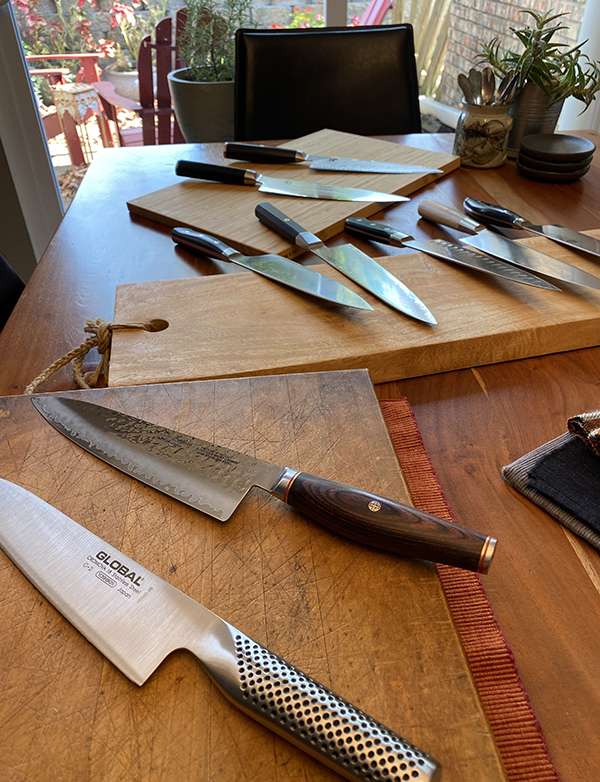 Japanese chef knives scattered on table