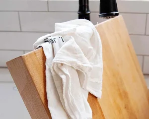wood cutting board in sink
