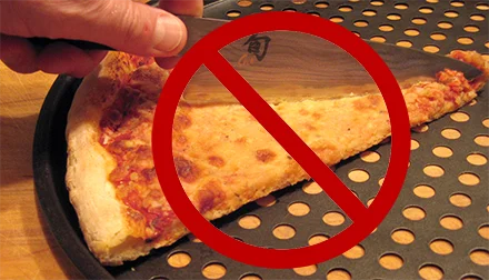 cutting pizza on steel pizza pan