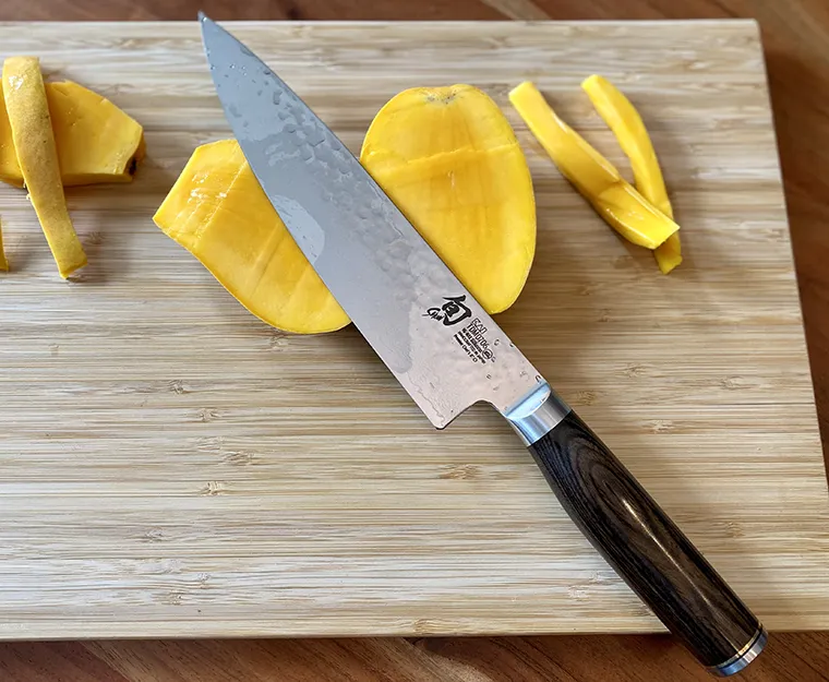 Shun Premier chef knife mastering a mango